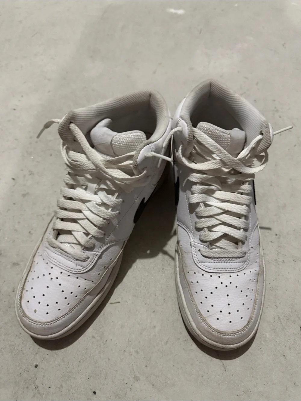 Nike White High-Top Sneakers with Black Swoosh
